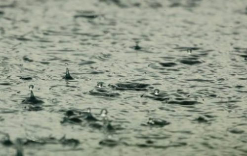 Image Of Many Raindrops Falling Into/Onto Water.